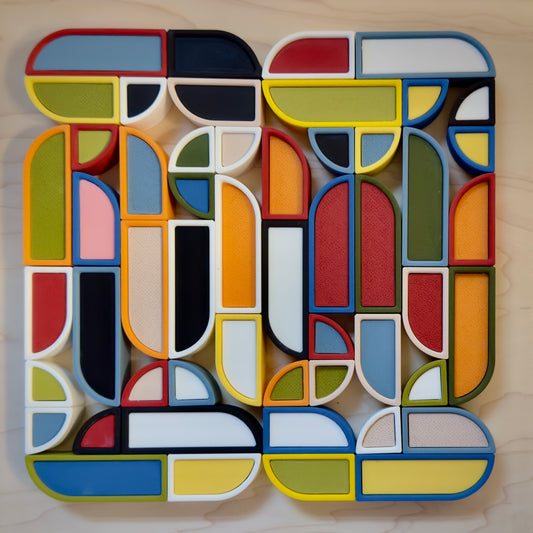 Marcel magnetic art board fully arranged with colorful geometric blocks in an abstract Bauhaus-style composition